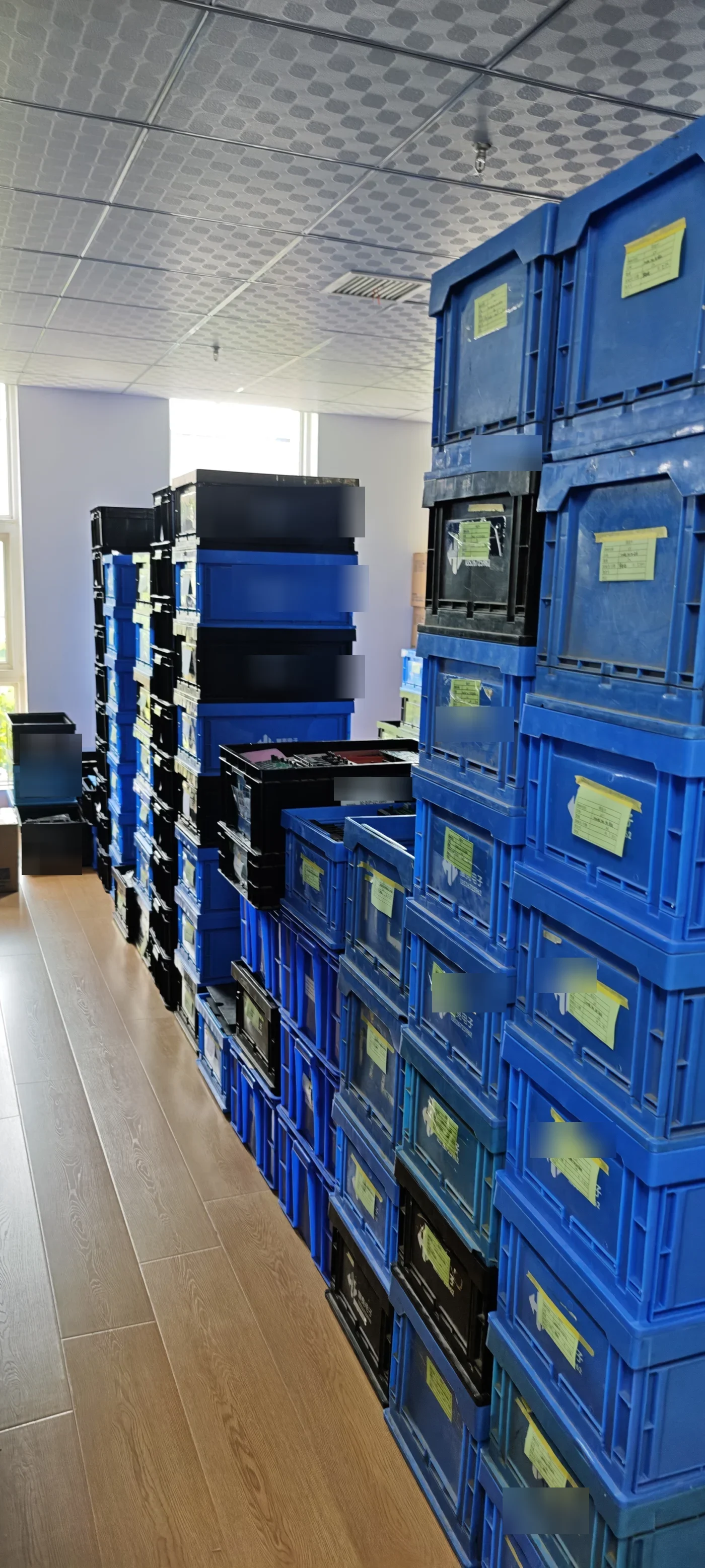 Component staging area with crated PoE switch boards awaiting assembly and testing